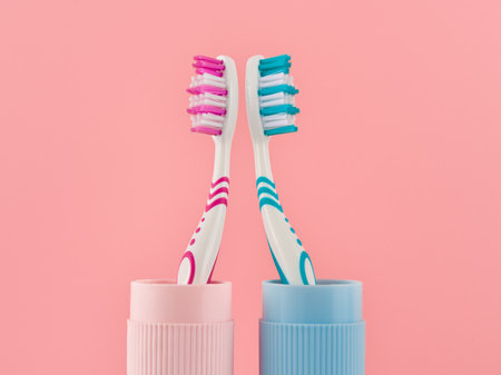 Two toothbrushes on a pink background from a low angle view. Studio shot.の写真素材