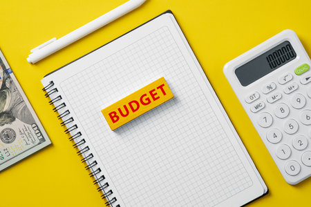 Block with the text Budget on notepad. Finance and budget planning - managing income, savings, and expenses.の写真素材