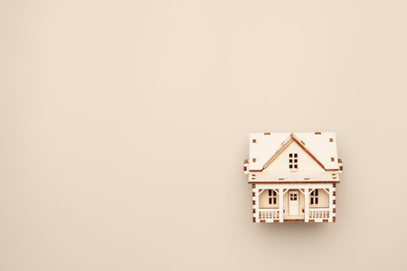Wooden house model with blank copy space for mortgage loan advertising or real estate offer.の写真素材