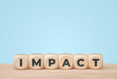Impact word on wooden cubes over blue background for social and business effect concept