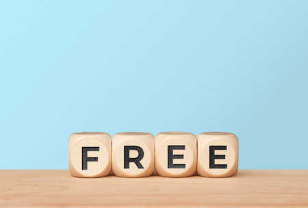 Free freedom concept with letter cubes on light blue background