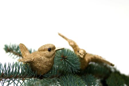 Christmas decoration. Two golden birds on fir branch. Selective focusの写真素材