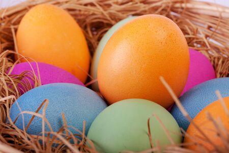 Closeup of colorful easter eggs in the nest, selective focus
