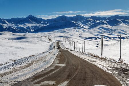 Road in snowy mountainsの写真素材