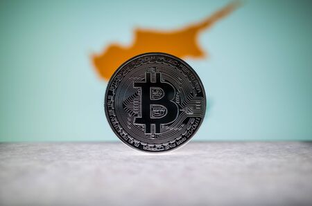 Physical silver version of Bitcoin BTC and Cyprus Flag on the background. Conceptual image for investors in cryptocurrency and Blockchain.の写真素材