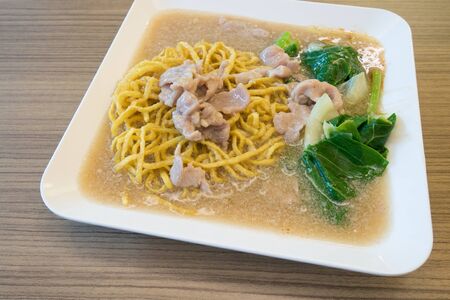 Stir-fried Fresh rice-flour noodles in thick gravy, Chinese and Thai Style food called "Rad Na"の写真素材