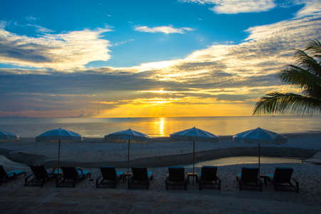 Relax on the beach canvas chair in the morning light.の写真素材