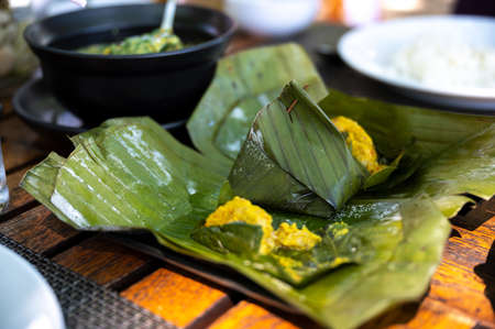 Closed up thai Steamed Fish Curry (Homok) on wooden table a thai breakfast in the southern.の写真素材