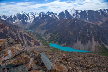 Beautiful lake in the mountains. Mountain lake aerial view. High mountains with glaciers. Blue sky, clouds.の写真素材
