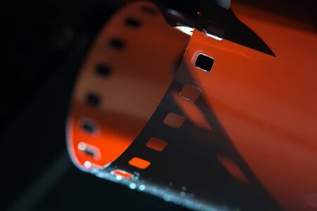 Photographic film close-up. Beautiful lighting. Shadows and relief of the film. Film Festival. The concept of cinematography and photo art.の写真素材