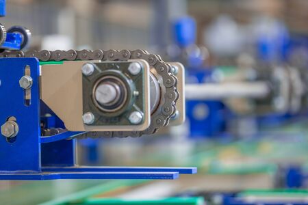 Industrial equipment. close-up photo. Refocused background. The iron components are blue. Chain and chain drive.の写真素材