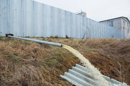 Industrial waste is discharged into the river. Nature pollution by industrial waste. Ecology...