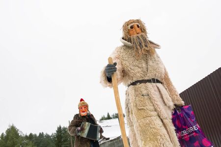 Russia. Tver region Village "White outside." January 7, 2020. Caroling in the village. National holidays and customs. People in fancy dress are walking along the street.のeditorial素材