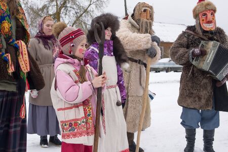 Russia. Tver region. The village "White Outside". January 7, 2020 Caroling in the village.National holidays and customs. Children in fancy dress are standing near the village house.のeditorial素材