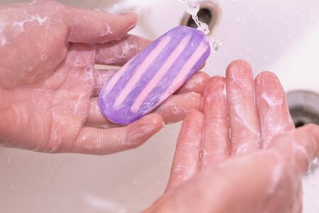 A man washes his hands with soap. Antibacterial soap. Close-up photo. Prevention of viral diseases...