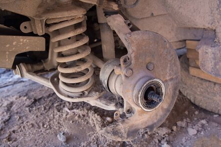 The old nave of a car without a wheel. The front suspension spring of the car. Front wheel drive car. Car repair, breakdown on the road.の写真素材