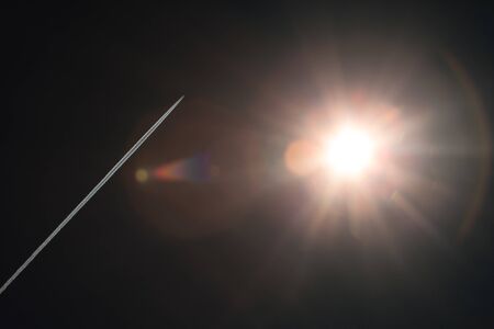 Coverage rocket trail against a dark background. A bright flash in the sky. Star in space. Space exploration.の写真素材