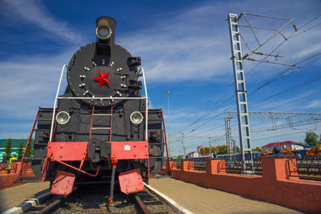 Monument to the old steam locomotive. Front view.