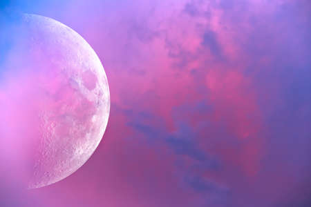The big moon against the backdrop of beautiful sunset clouds.の写真素材