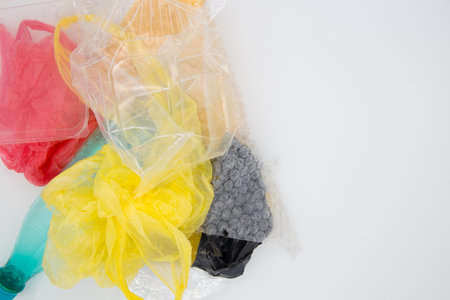 Plastic bags and bottles on a white background. Plastic environmental pollution concept.の写真素材