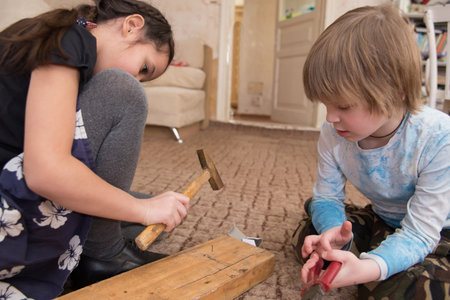 Children learn to hammer in nails.の写真素材