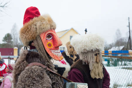 People in demon masks are caroling in a Russian village. folk holidays and customs in russia.の写真素材