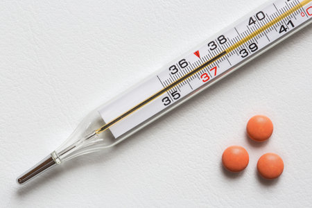 A medical thermometer shows a temperature of 38 degrees. Seasonal diseases. Illness and fever.の写真素材