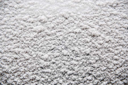 Background image. Snow background. Snow on glass, close-up.