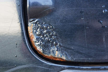 Rust stain on the car body. Close-up photo.