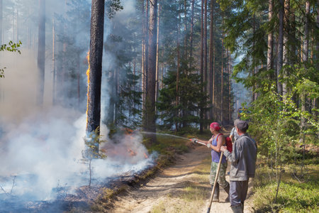 June 23, 2021. Russia. Tver region. Forest workers extinguish a forest fire.の写真素材
