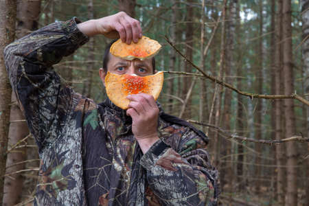 A man holds a hallucinogenic mushroom fly agaric in his hands.の写真素材