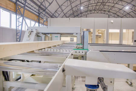 Woodworking Machine. There is a wooden beam on the conveyor.の写真素材