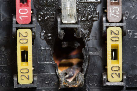 Burnt out car fuse box. Defective fuse block. close-up photo.の写真素材
