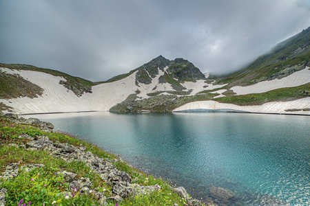 An alpine lake with beautifully colored water.の写真素材