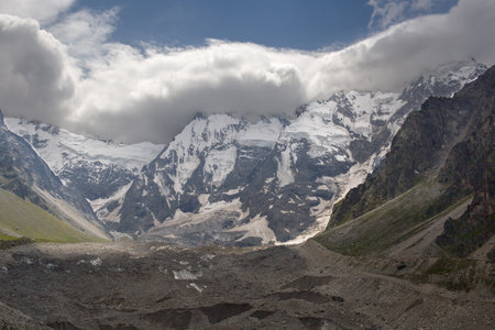 Snowy mountain peaks with beautiful cloudsの写真素材