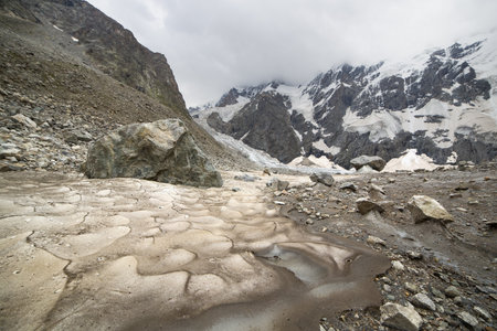 Glacier surface. melting glacier against the backdrop of a mountain range.の写真素材