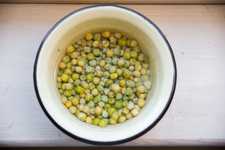 peas prepared for planting lie in a bowl.の写真素材