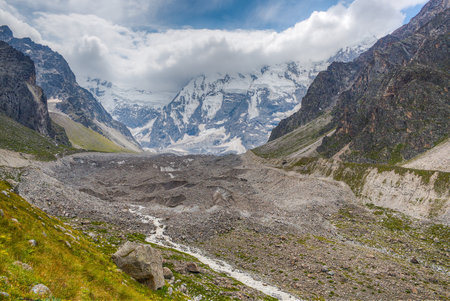 Melting glacier, mountain river and high snow-capped mountains.の写真素材