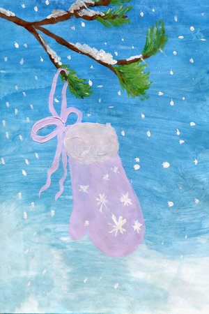 A winter mitten hangs on a tree branch.の写真素材