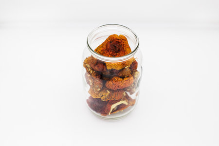 Dried amanita mushrooms in a glass jar.の写真素材