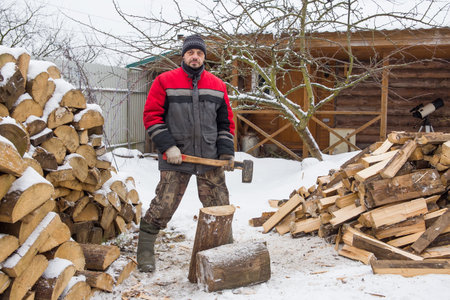 A man is splitting wood for the bathhouse.の写真素材