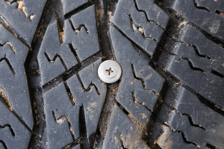 A metal screw got stuck in a car wheel.