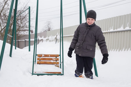 A European boy walks through deep snow.の写真素材