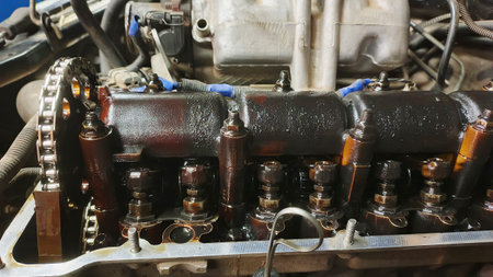 Disassembled car engine with camshaft and valves.