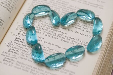 Blue transparent stones on the book's pageの写真素材