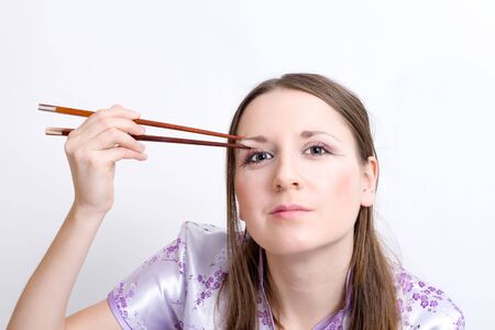 Woman with chopsticks for sushiの写真素材