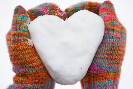 heart of snow in colorfull glovesの写真素材
