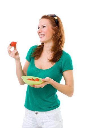 Woman eating strawberry side view wide smile green shirtの写真素材