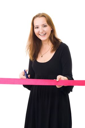 Woman cutting a red ribbon for a ceremony isolated on whiteの写真素材