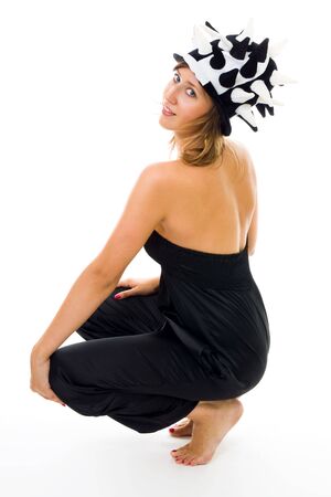 woman in party chess like hat squat and turn back headの写真素材